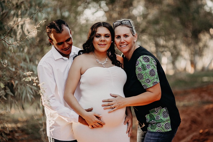 parents to be Manu and Shacquira pose for  a photo in outback Queensland with their midwife